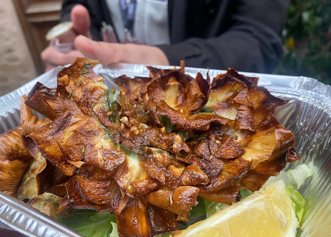 Enjoying crispy, golden fried artichokes as a tasty snack on my authentic Rome food tour