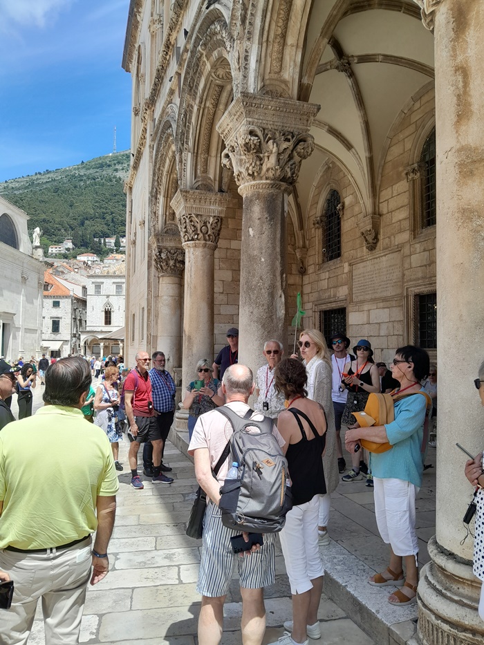 Guided tour group at the Rector's Palace in Dubrovnik Tourists listening to a guide in front of the historic Rector's Palace in Dubrovnik's Old Town