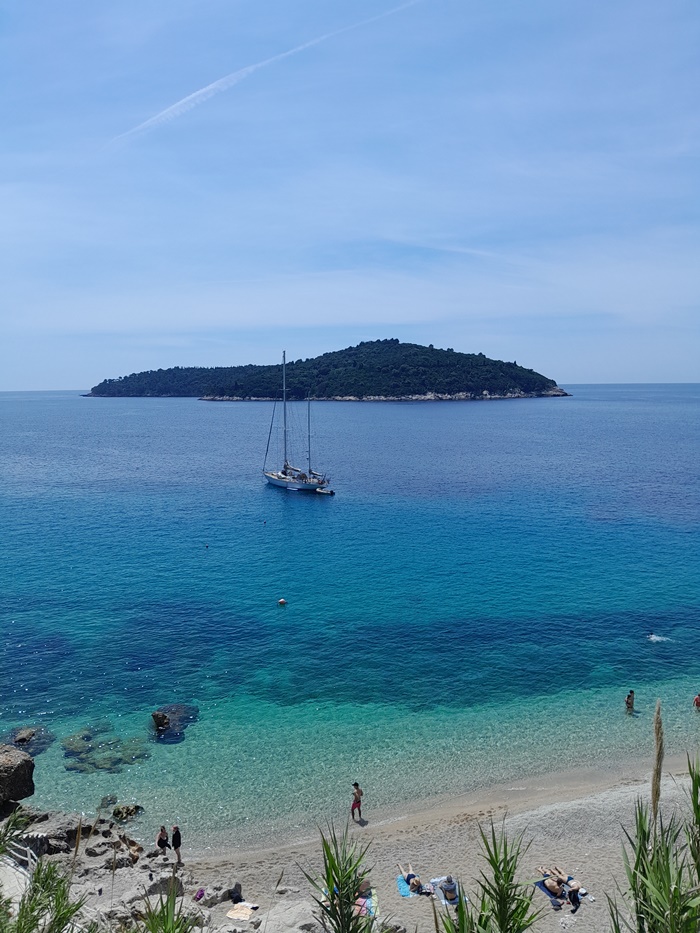A gorgeous view of Lokrum Island from Banje Beach, with clear waters and plenty of greenery to take in.