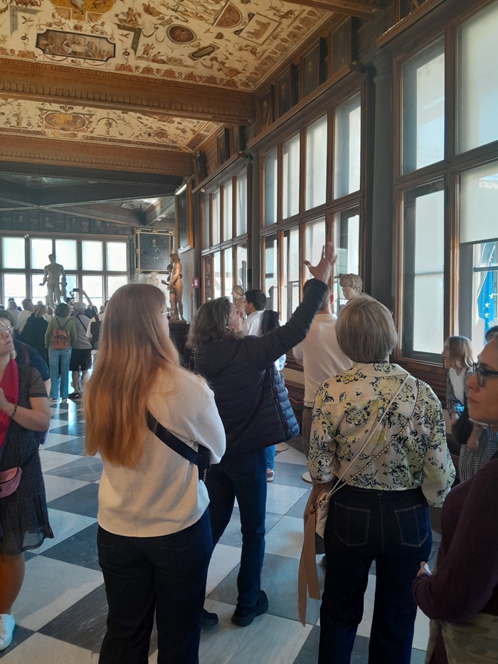 Tourists visiting the Uffizi Gallery on a small-guided tour