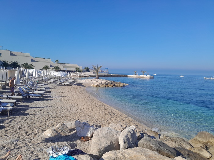 Beach beneath the Valamar President Hotel in Babin Kuk with clear blue water and pebble shore